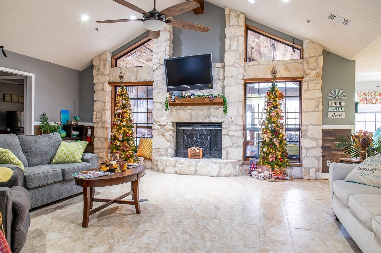 Living room with stone fireplace and comfortable seating